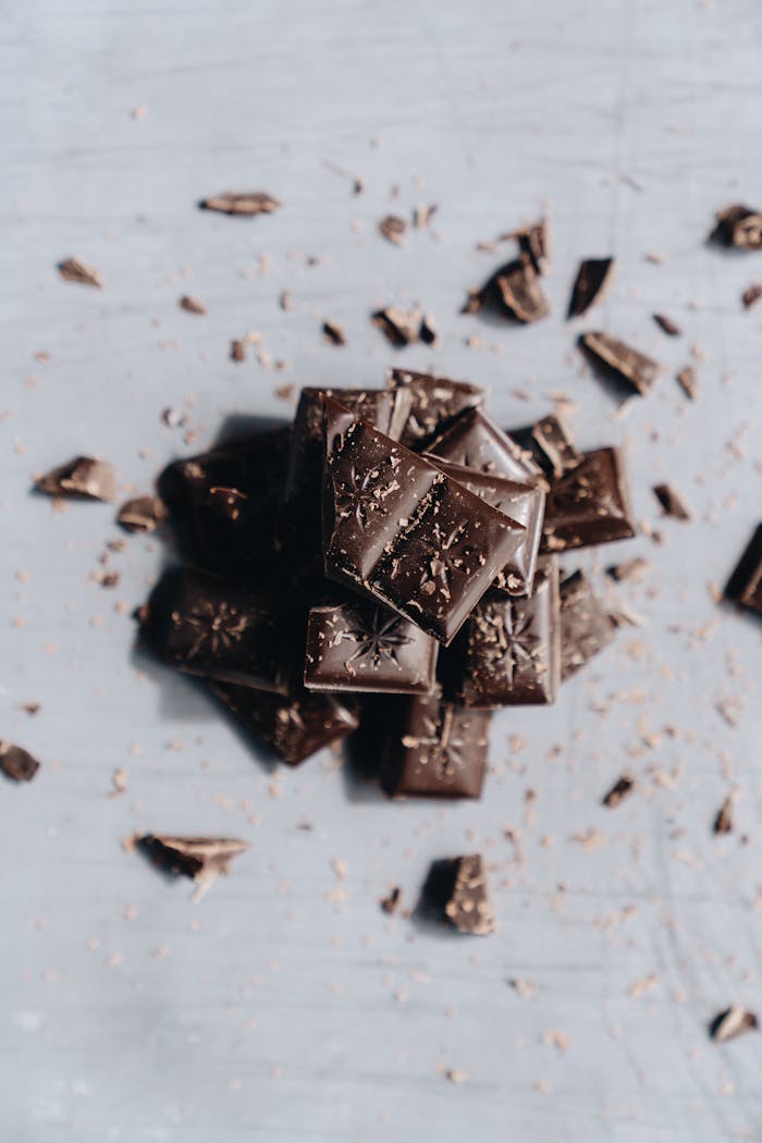 A stack of gourmet dark chocolate bars and chunks, perfect for dessert and culinary photography.